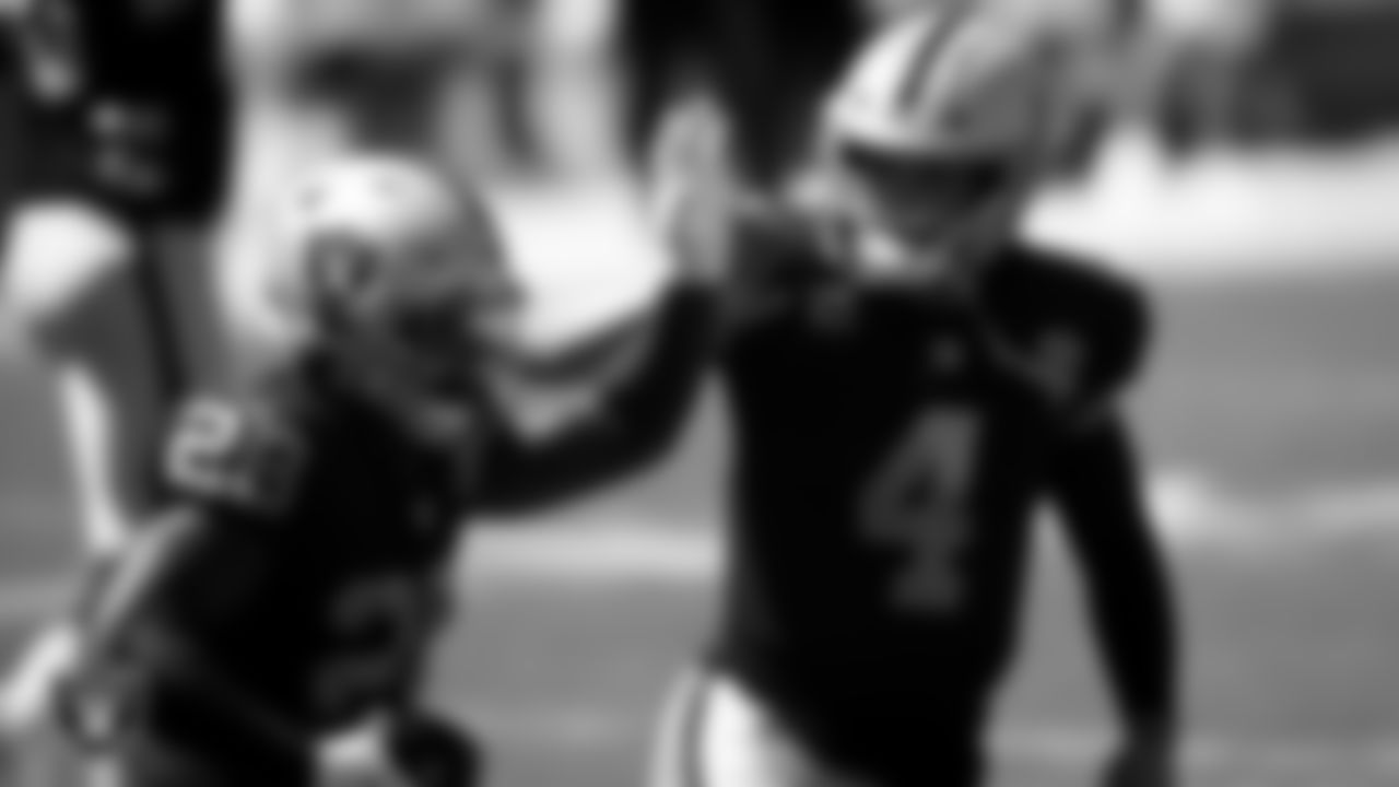 Las Vegas Raiders running back Josh Jacobs (28) is congratulated by quarterback Derek Carr (4) after rushing for a 1-yard touchdown during the regular season away game against the Carolina Panthers.
