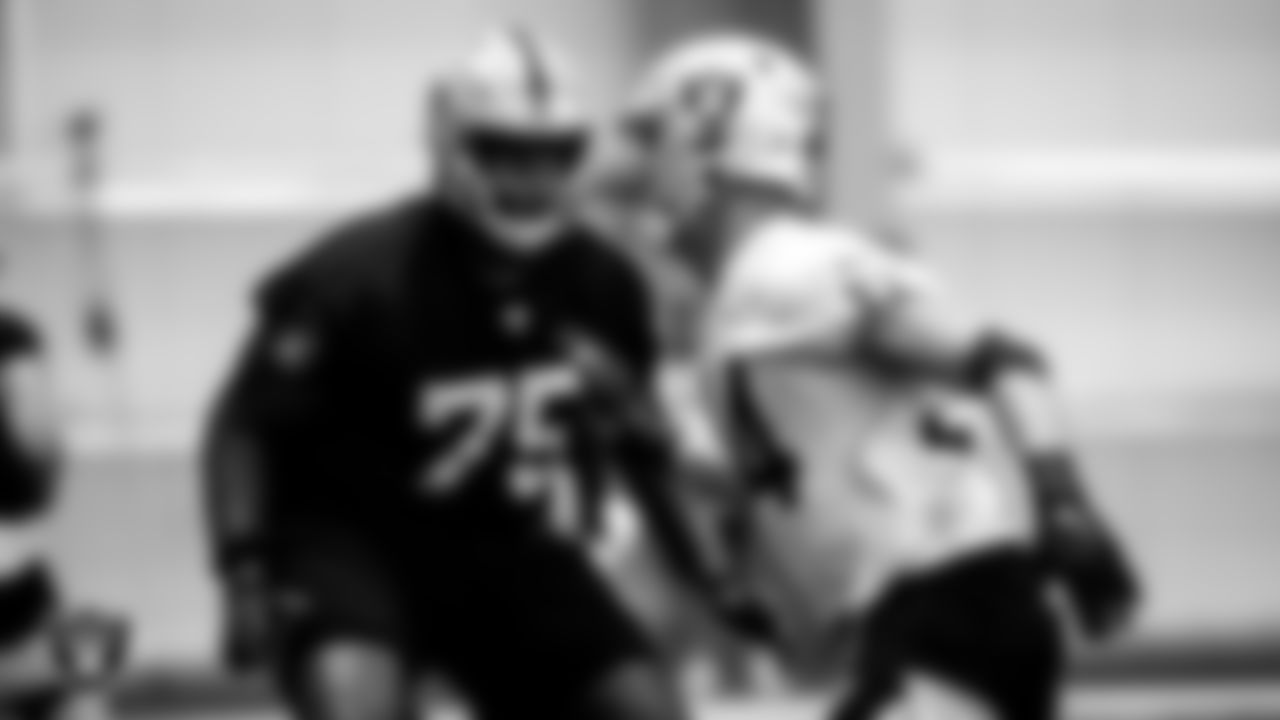 Las Vegas Raiders tackle Brandon Parker (75) and defensive end Carl Nassib (94) during practice.