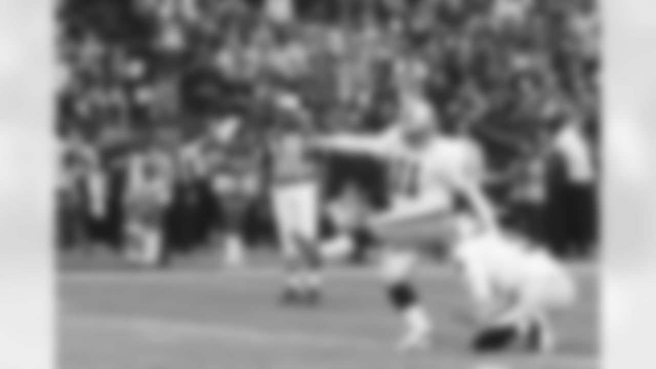 K Sebastian Janikowski kicks the PAT out of the hold of P Shane Lechler.