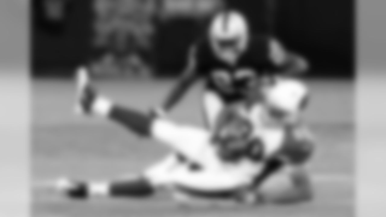 Cardinals WR Isaiah Williams makes the catch with Raiders CB Jeremy Ware close behind.