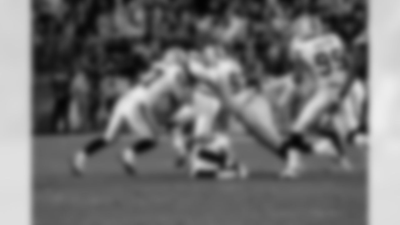 DT Tommy Kelly and S Matt Giordano stop the ball carrier.
