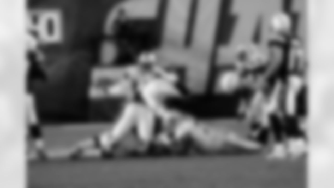 DT John Henderson brings down the ball carrier.