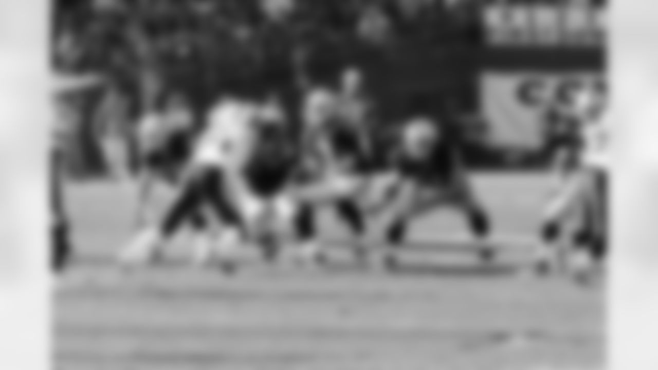 QB Carson Palmer takes the snap behind the protection of his offensive line.