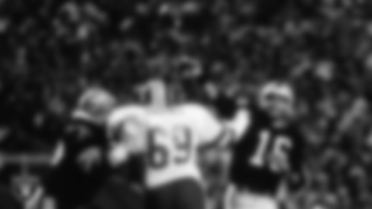 Los Angeles Raiders guard Charley Hannah (73) blocks as quarterback Jim Plunkett (16) passes during Super Bowl XVIII against the Washington Football Team at Tampa Stadium, Sunday, January 22, 1984, in Tampa, Fla.