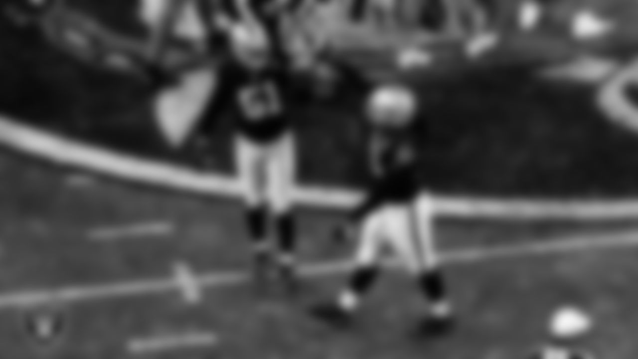Las Vegas Raiders defensive end Kendal Vickers (91) celebrates with defensive end Vic Beasley (51) after sacking the quarterback during the regular season home game against the Miami Dolphins.