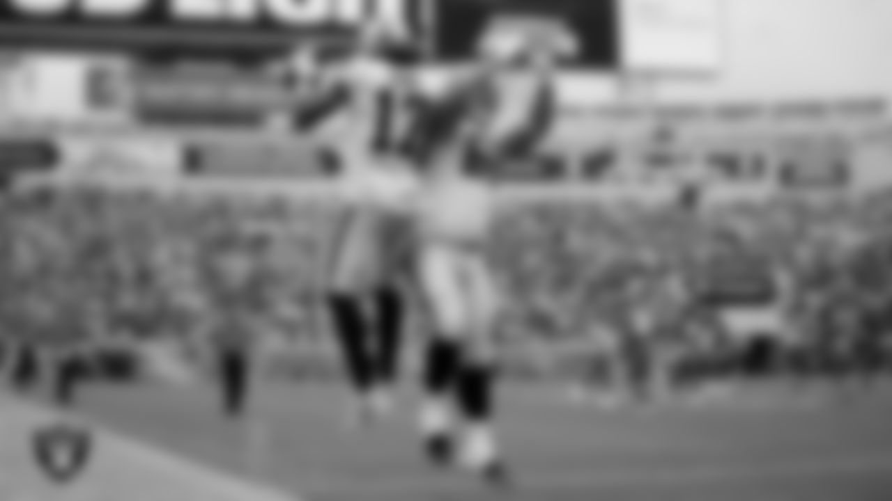 Las Vegas Raiders wide receiver Davante Adams (17) celebrates with center Andre James (68) after making a 38-yard touchdown catch during the regular season away game against the Jacksonville Jaguars at TIAA Bank Field.