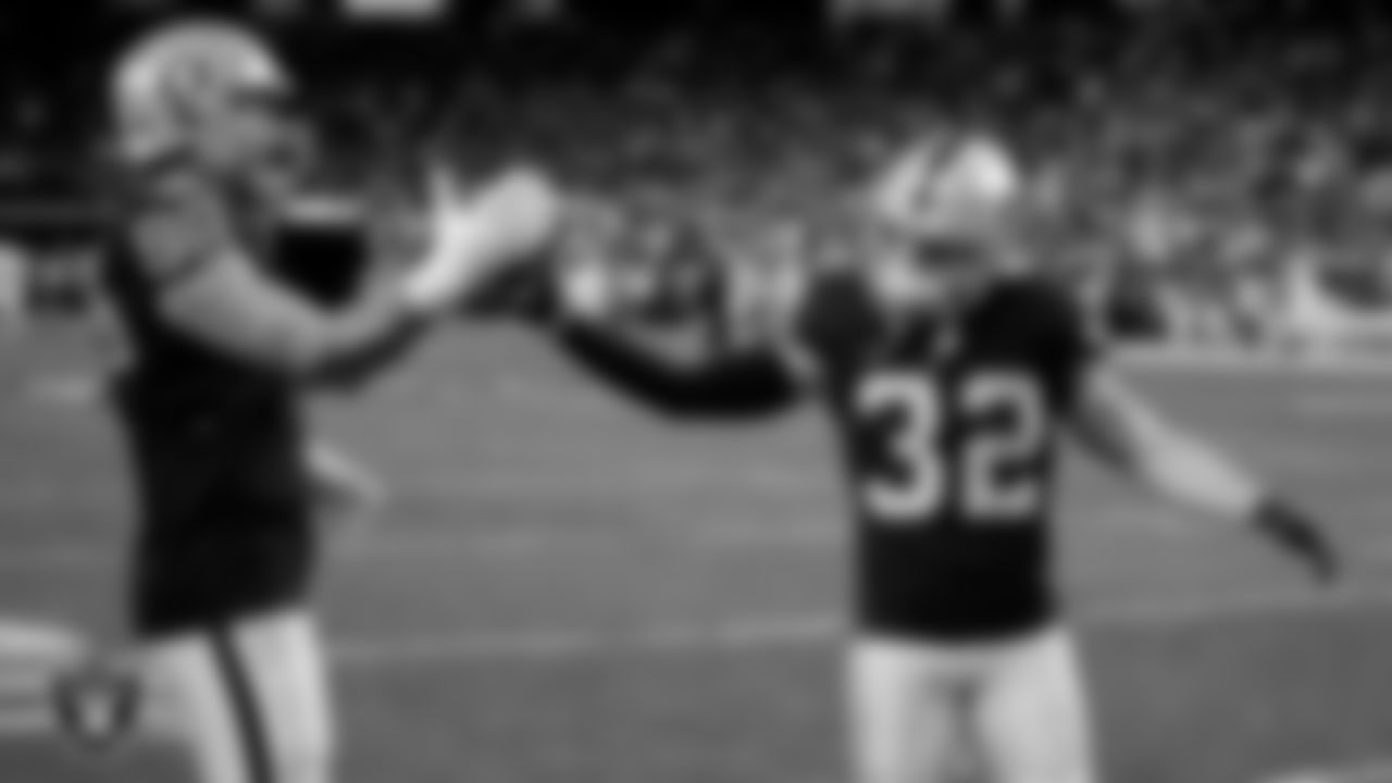Las Vegas Raiders defensive end Maxx Crosby (98) and safety Dallin Leavitt (32) warming up before the regular season home game against the Los Angeles Chargers.