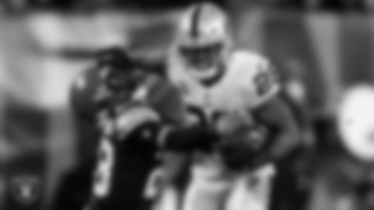 Las Vegas Raiders running back Josh Jacobs (28) stiff arms the defender during the regular season away game against the Cleveland Browns.