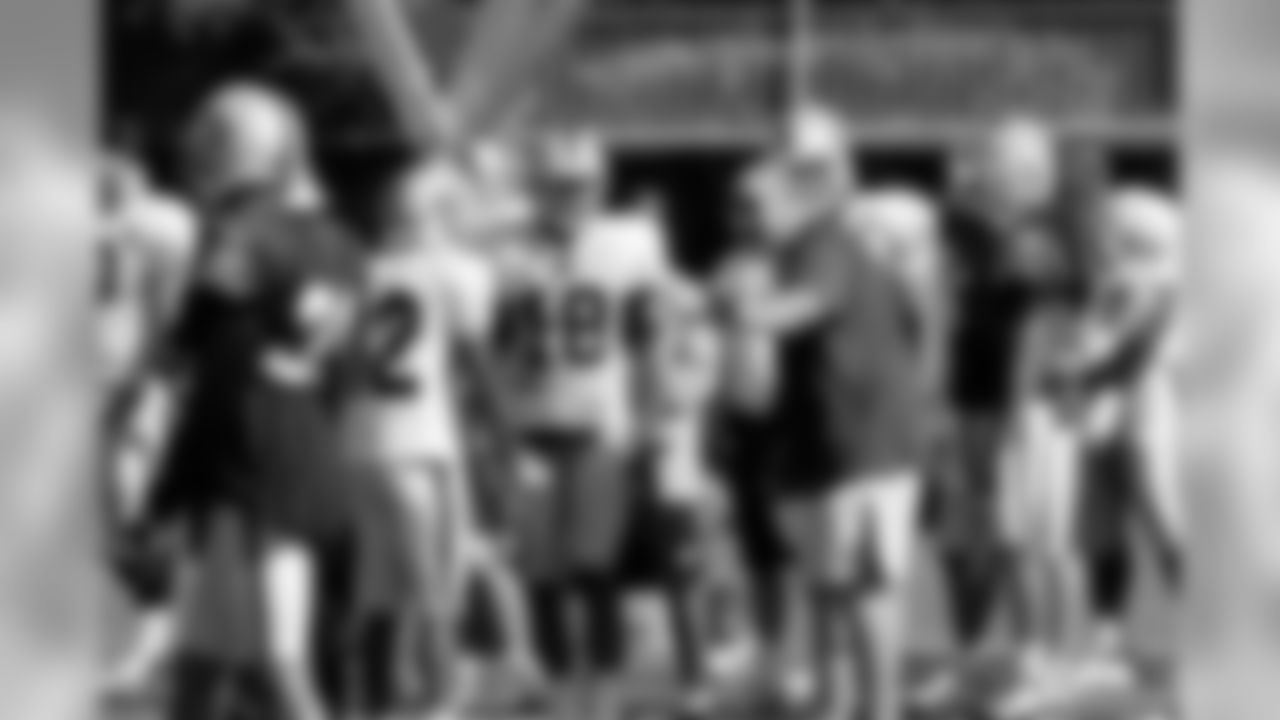 Head Coach Tom Cable speaks to some of the wide receivers. Photo By Tony Gonzales