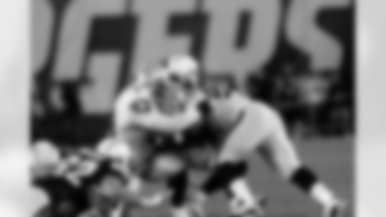 DT Tommy Kelly and DE Lamarr Houston put the squeeze on QB Philip Rivers.