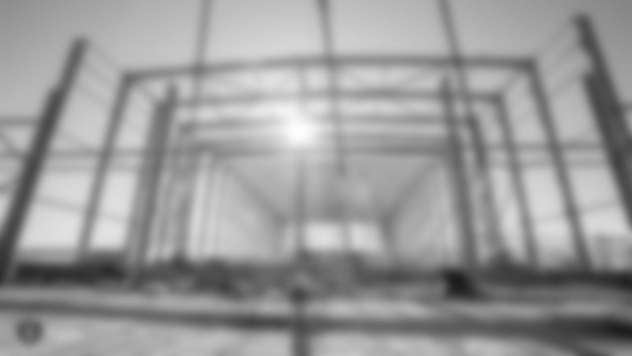 Constructions crews at the Raiders' Henderson HQ worksite hold a Topping Out event by hoisting the last steel beam for the structure into place.