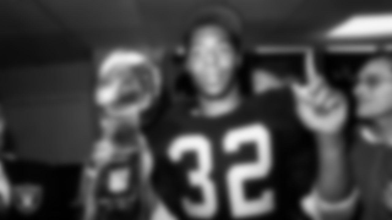 Los Angeles Raiders running back Marcus Allen (32) celebrates in the locker room with the Vince Lombardi Trophy after Super Bowl XVIII against the Washington Football Team at Tampa Stadium, Sunday, January 22, 1984, in Tampa, Fla.