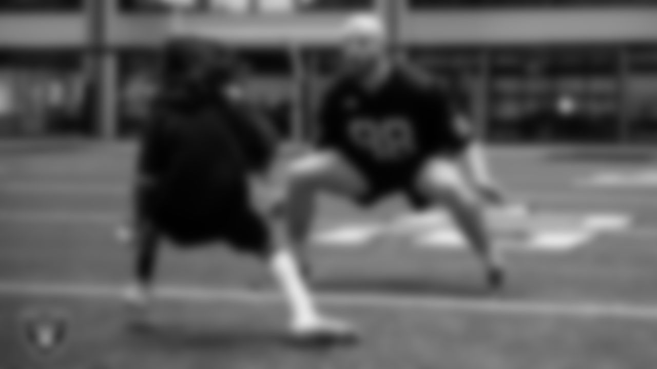 Las Vegas Raiders defensive end Maxx Crosby (98) goes through drills with a participant during the Raiders Skills Camp.