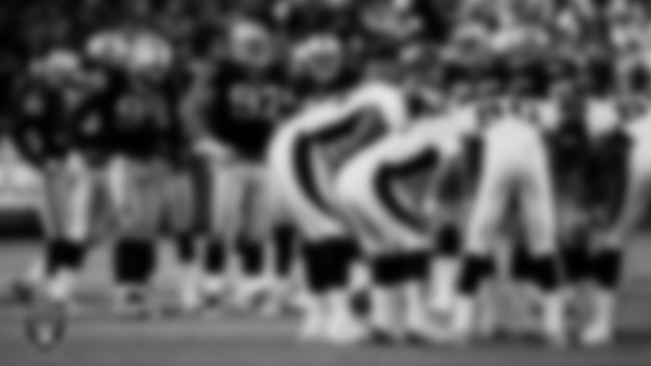 The Raiders defense huddles during the regular season home game against the Denver Broncos at Network Associates Coliseum, Sunday, December 22, 2002, in Oakland, Calif.