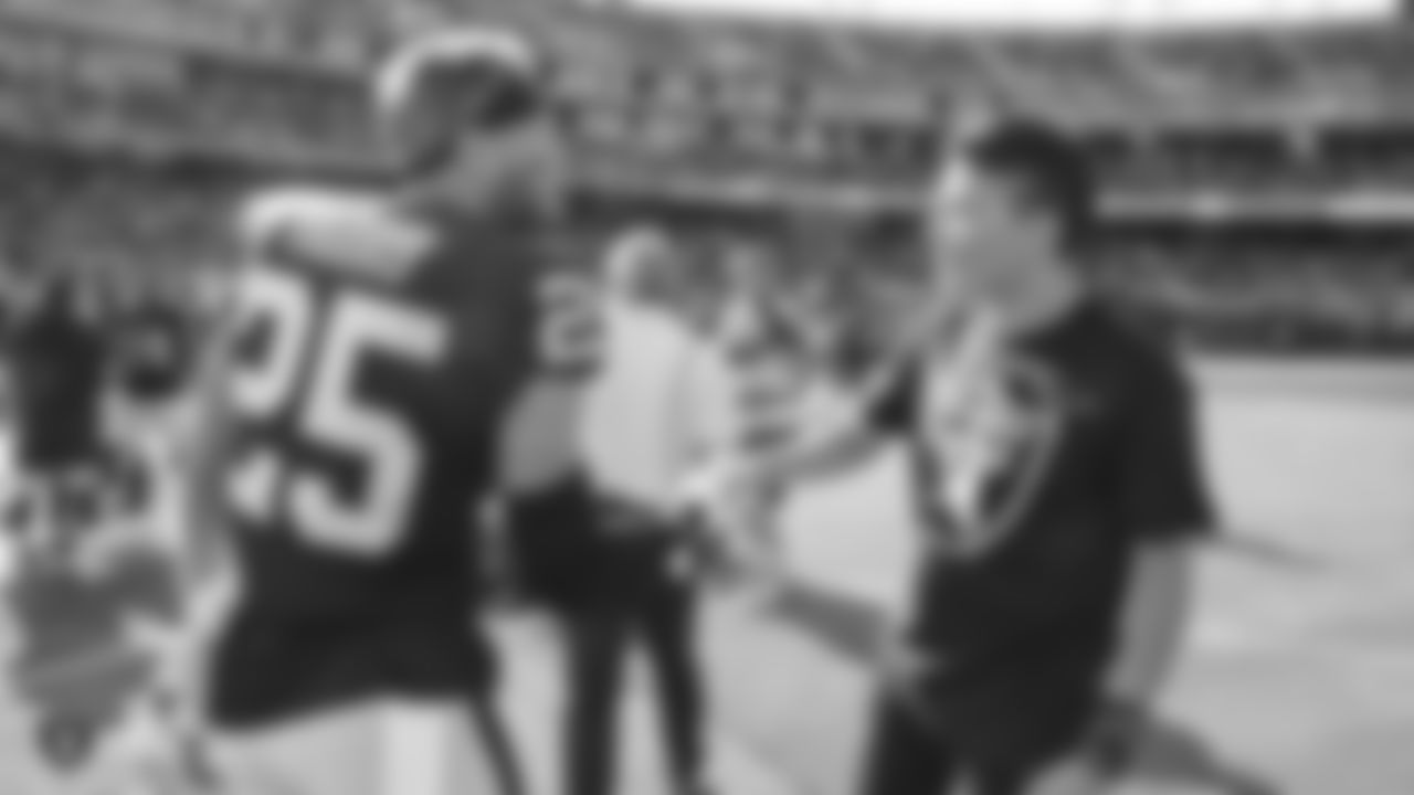 Grandson of Raiders alumnus Tom Flores, Brian Flores, with safety Erik Harris (25) after performing the national anthem before the Raiders preseason game against the Los Angeles Rams.