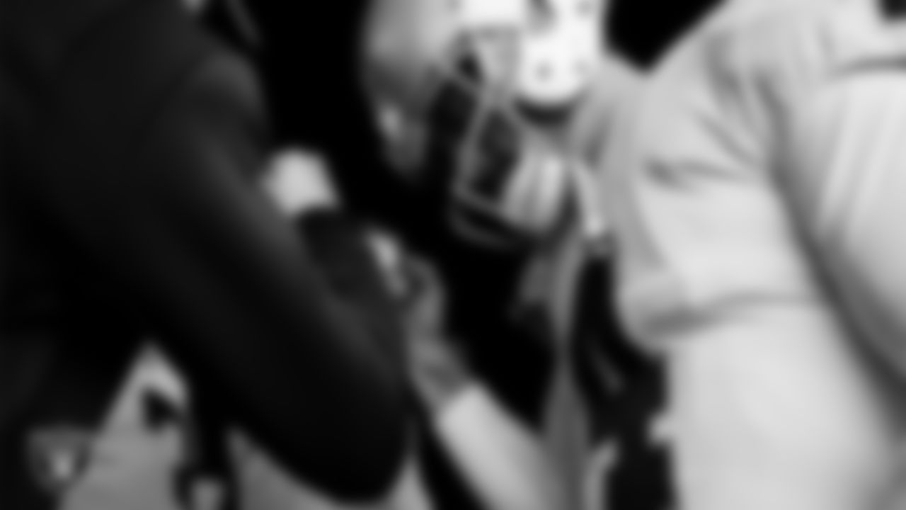 The Las Vegas Raiders quarterbacks huddle in the tunnel before the regular season away game against the Denver Broncos at Empower Field at Mile High.