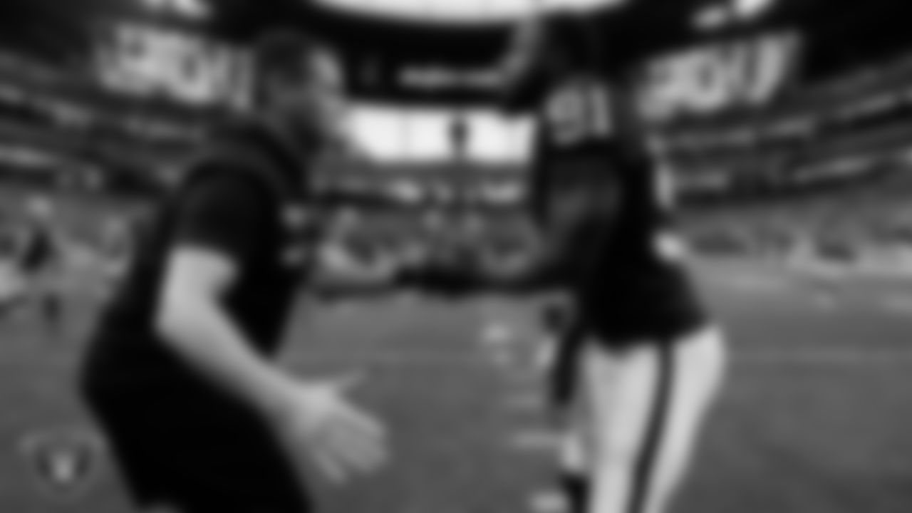 Las Vegas Raiders head strength and conditioning A.J. Neibel and defensive end Yannick Ngakoue (91) before the regular season home game against the Washington Football Team.