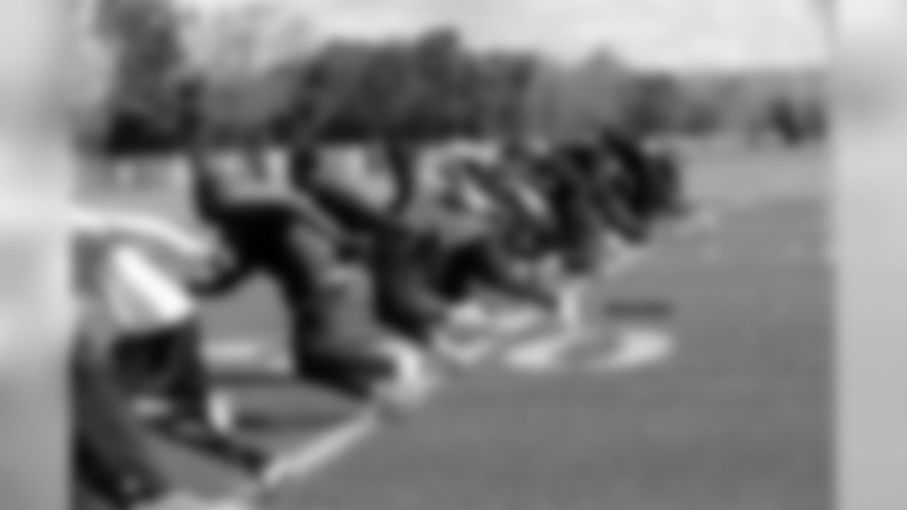 The defensive backs take off in an on-field sprint.