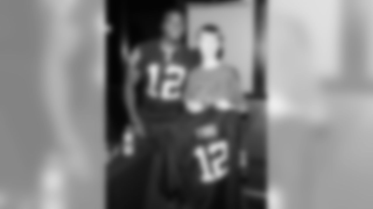 WR Jacoby Ford poses for a photo with a young fan.