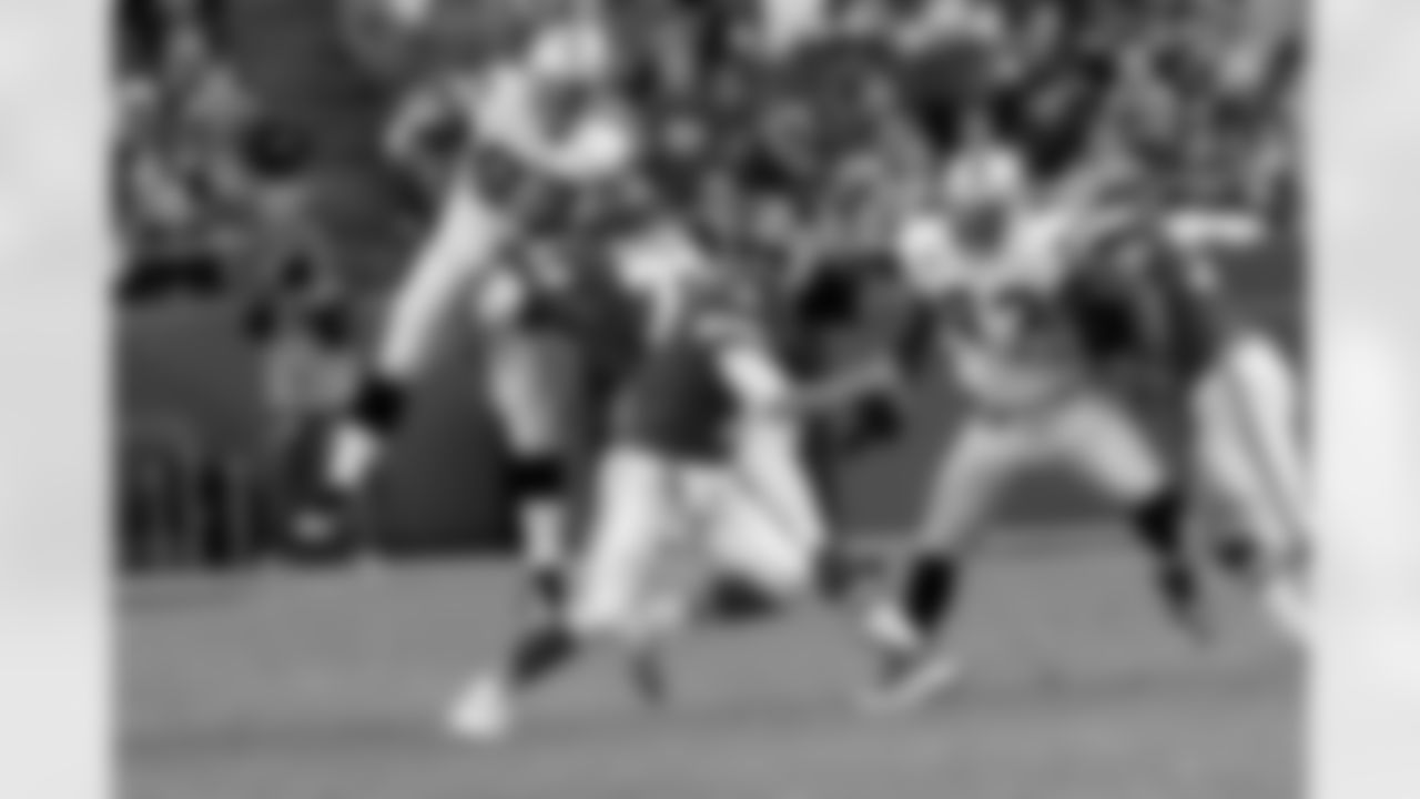DE Lamarr Houston gets some air to block the passing lane and DT Tommy Kelly gets in the QB's face.