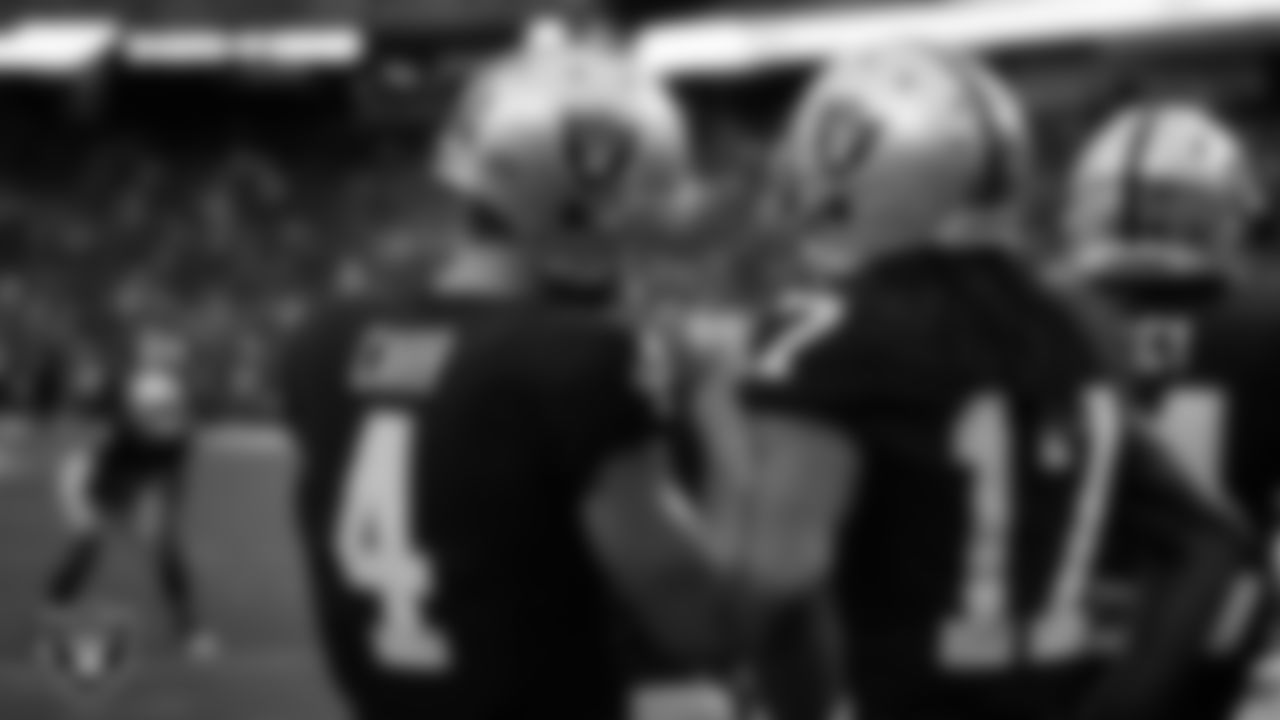 Las Vegas Raiders quarterback Derek Carr (4) and wide receiver Davante Adams (17) warming up before the preseason home game against the Minnesota Vikings at Allegiant Stadium.