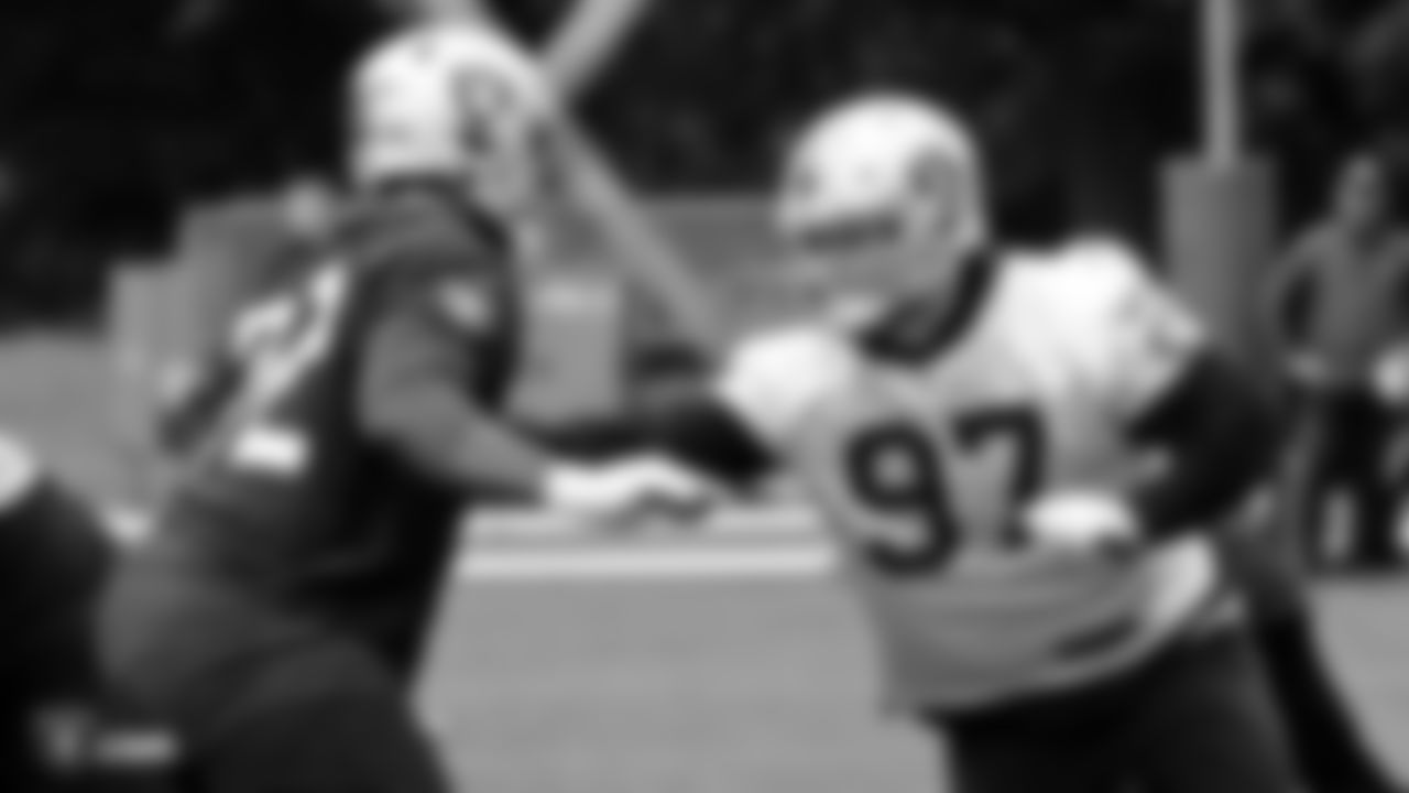 Raiders tackle David Sharpe (72) blocks defensive end Josh Mauro (97) on the field during practice.