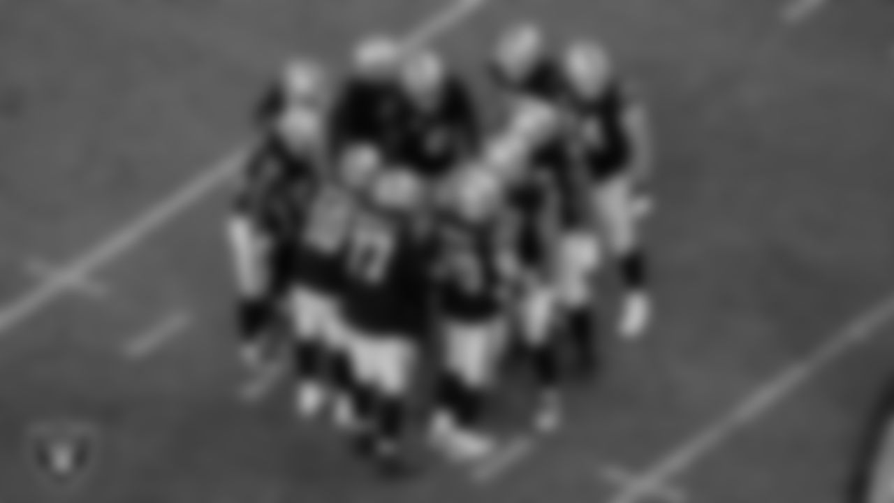 The Las Vegas Raiders huddle during the regular season home game against the Green Bay Packers at Allegiant Stadium.