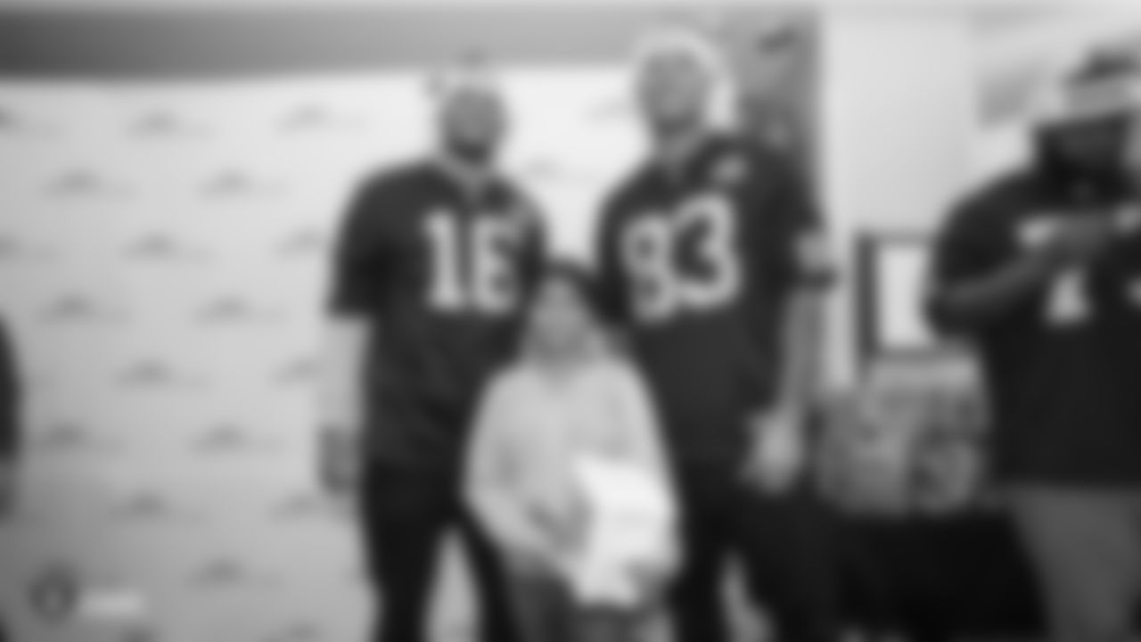 Raiders wide receiver Tyrell Williams (16) and tight end Darren Waller (83) pose for a photo with a kid during a visit to UCSF Benioff Children's Hospital Oakland.