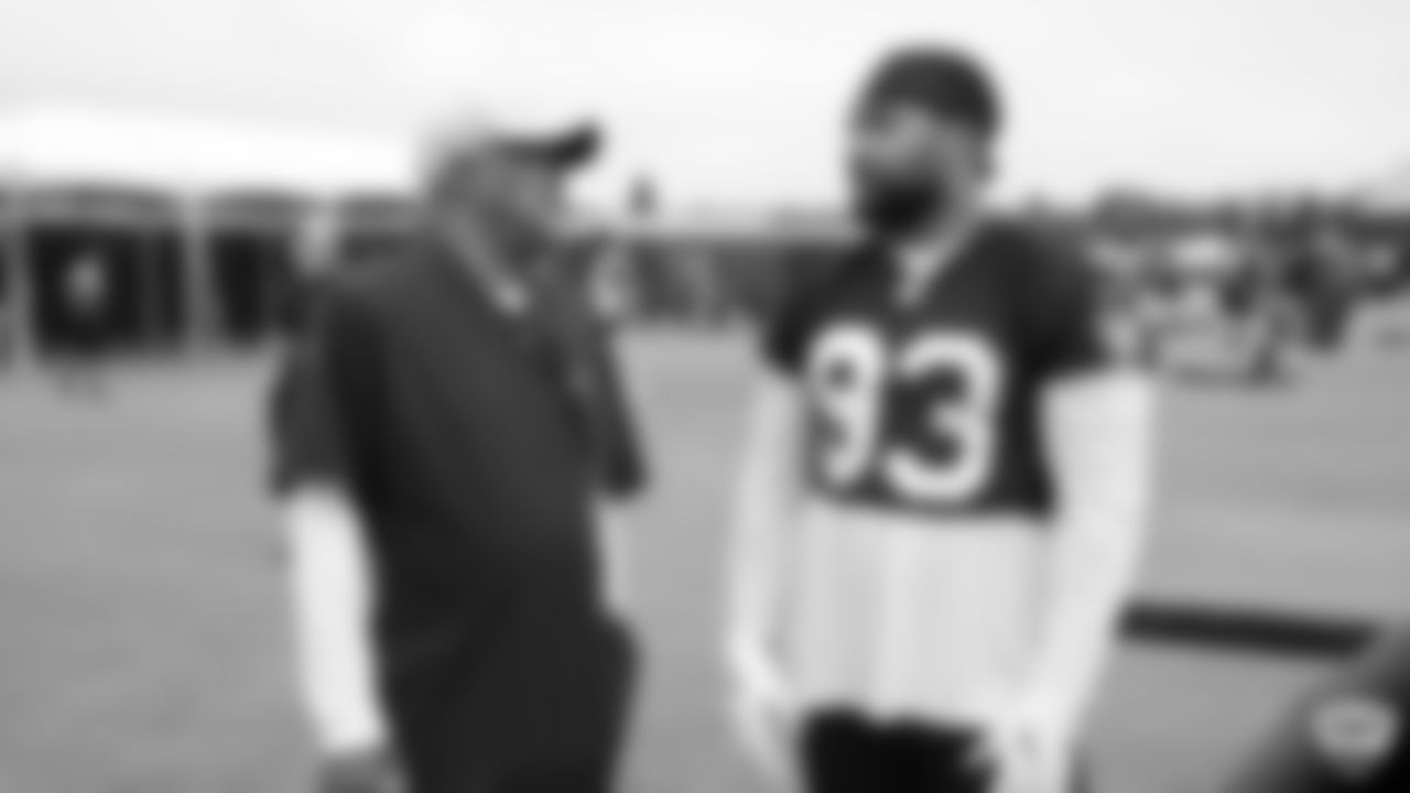 Raiders alumnus George Atkinson and defensive end Alex Barrett (93) on the field for practice at 2019 Training Camp.