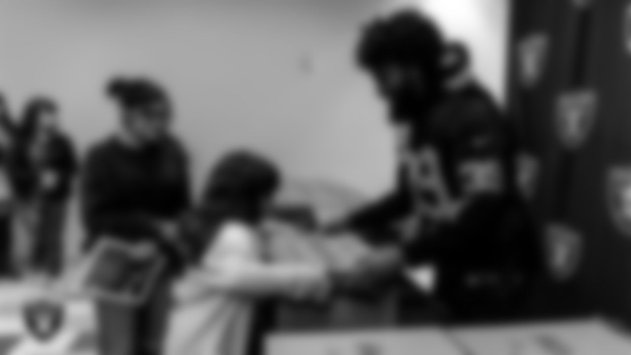 Las Vegas Raiders Nate Hobbs (39) distributes Thanksgiving meals to community members at the Pearson Community Center.