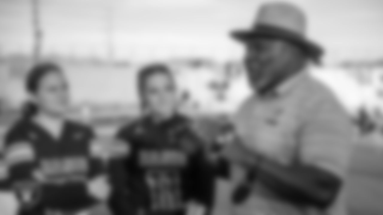 Las Vegas Raiders alumnus Roy Hart talks to Basic High School's girls flag football team after presenting their coach, Ken Ward, with the Tom Flores High School Coach of the Week award.