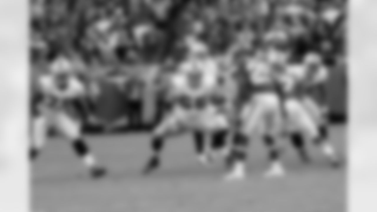 QB Carson Palmer takes the snap behind the protection of his offensive line.
