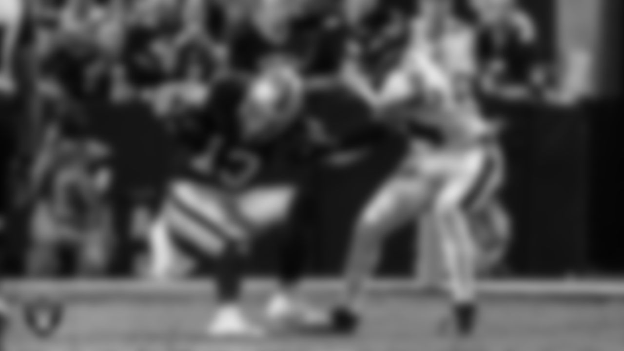 Las Vegas Raiders wide receiver Hunter Renfrow (13) breaks a tackle during the regular season home game against the Baltimore Ravens.