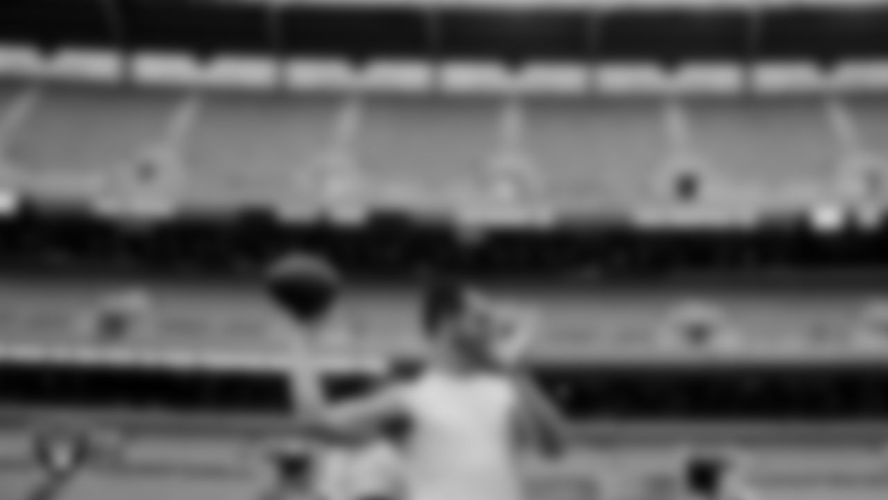 The Raiders warm up before the regular season game against the Cleveland Browns at FirstEnergy Stadium.