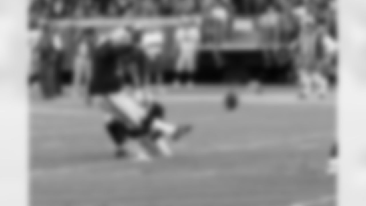 K Sebastian Janikowski kicks a PAT out of the hold of P Shane Lechler.