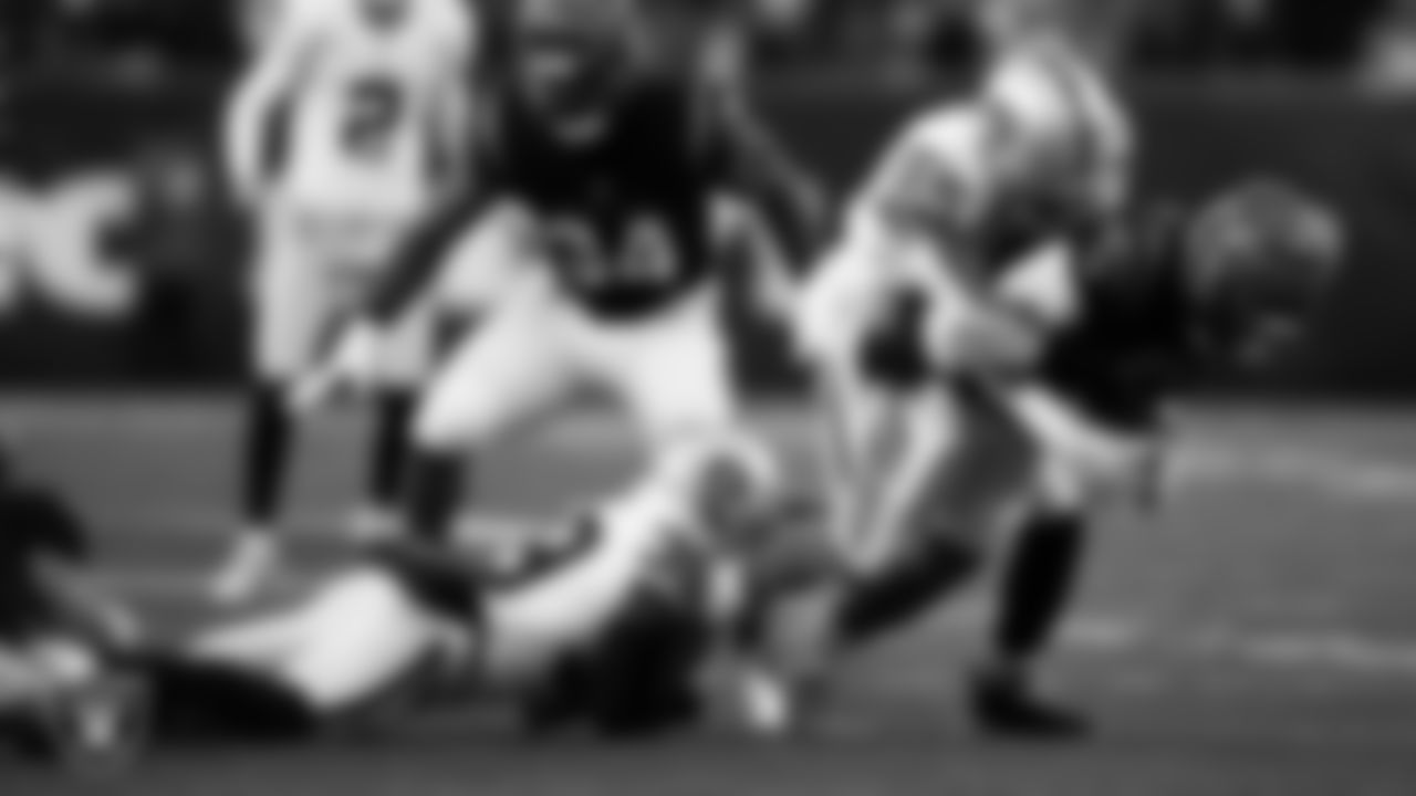 Las Vegas Raiders cornerback Nate Hobbs (39) and linebacker Marquel Lee (55) make a tackle during the postseason away game against the Cincinnati Bengals.