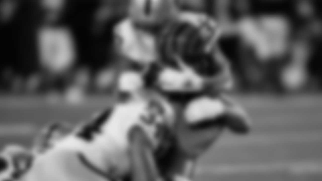 Las Vegas Raiders linebacker K.J. Wright (34) and safety Roderic Teamer (33) make a tackle during the postseason away game against the Cincinnati Bengals.