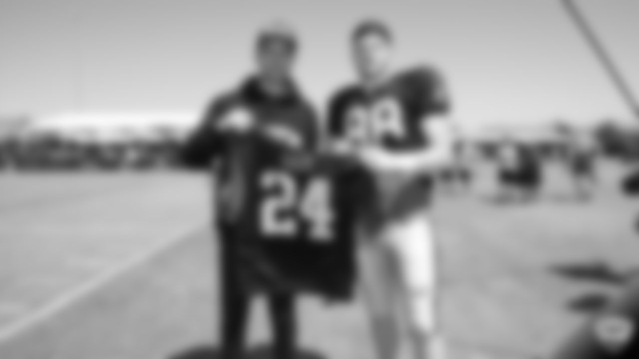 Raiders defensive end Maxx Crosby (98) gives rapper and Bay Area native G-Eazy his honorary Raiders jersey after practice at 2019 Training Camp.