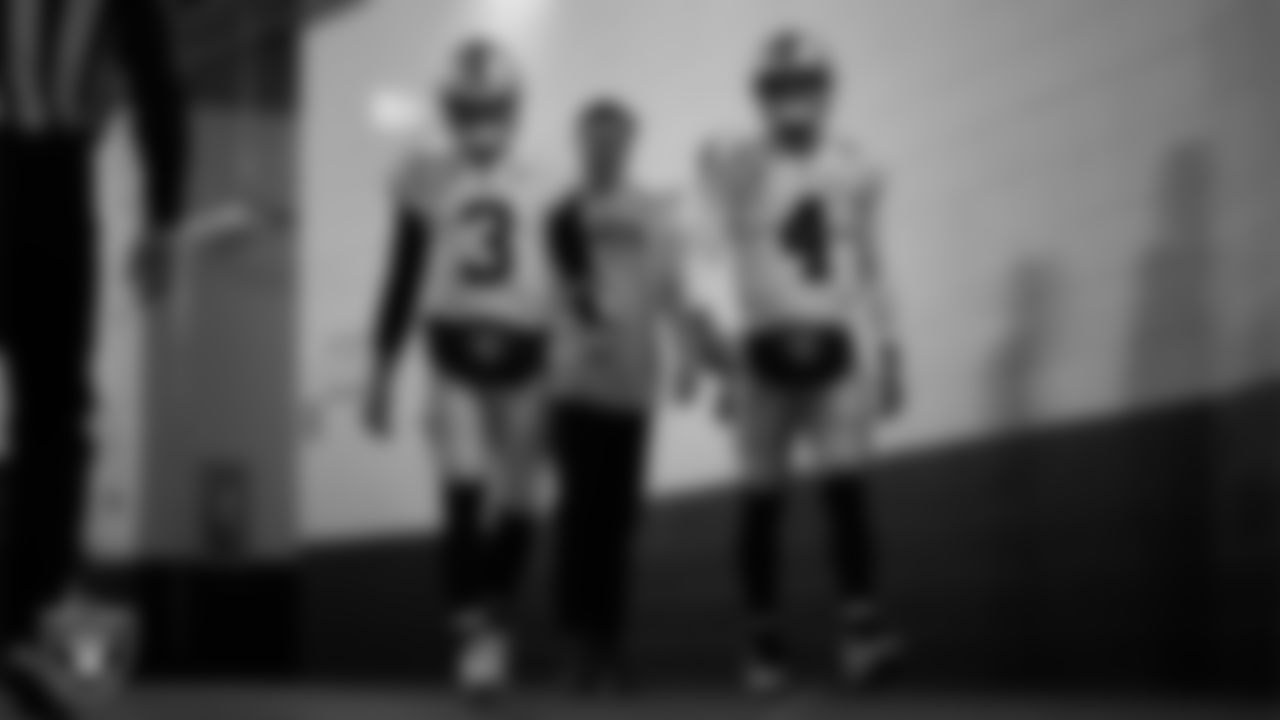 Las Vegas Raiders quarterback Jarrett Stidham (3), quarterback Chase Garbers (15) and quarterback Derek Carr (4) walk down the tunnel before the regular season away game against the Denver Broncos at Empower Field at Mile High.