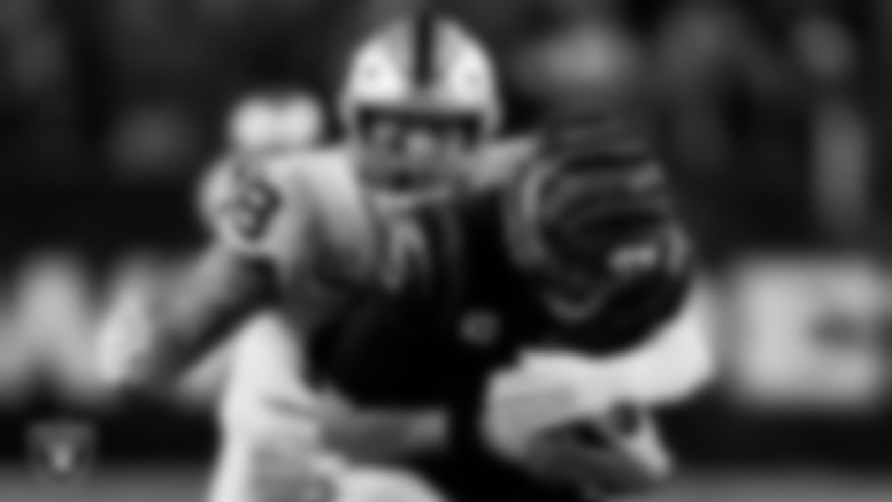 Las Vegas Raiders defensive end Maxx Crosby (98) sacks the quarterback during the postseason away game against the Cincinnati Bengals.