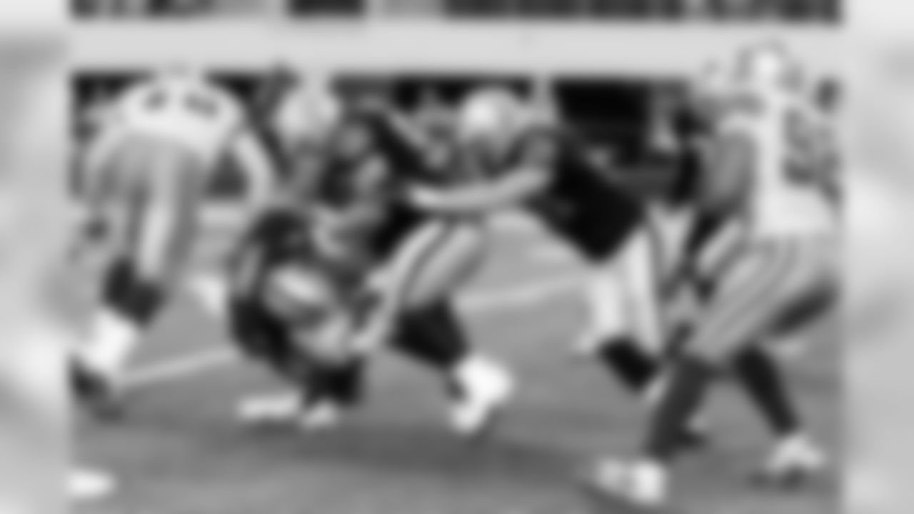 The Raiders gang tackle the Cowboys ballcarrier. Photo by Tony Gonzales.