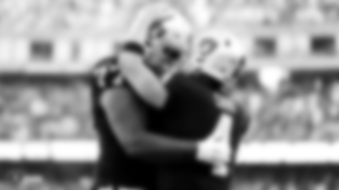 Raiders tackle Trent Brown (77) celebrates with quarterback Derek Carr (4) during the regular season game against the Cincinnati Bengals.