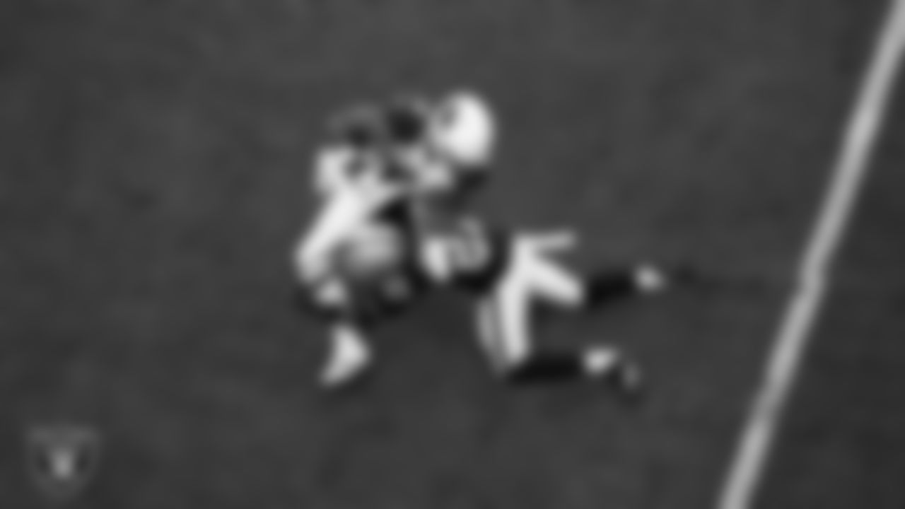 Las Vegas Raiders cornerback Amik Robertson (21) makes a tackle during the regular season home game against the Arizona Cardinals at Allegiant Stadium.