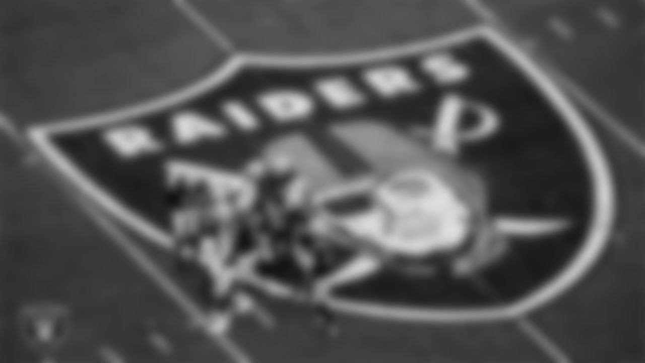 The Las Vegas Raiders defense huddles during the regular season home game against the Houston Texans at Allegiant Stadium.
