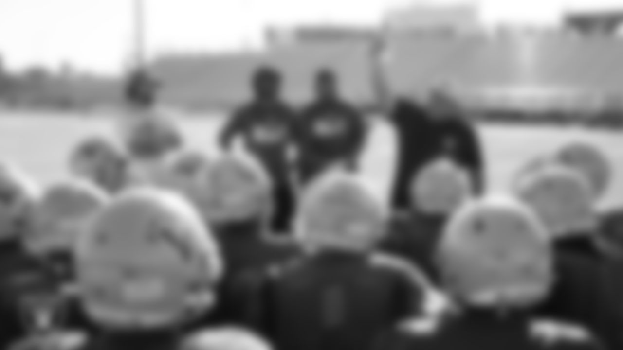 Las Vegas Raiders football development manager Jordan Aguilar hands out gloves to to the Western School football team after their practice at Western High School.