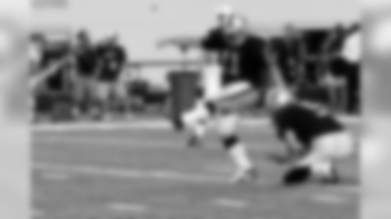 P Shane Lechler holds while K Sebastian Janikowski kicks an extra point. Photo by Tony Gonzales.