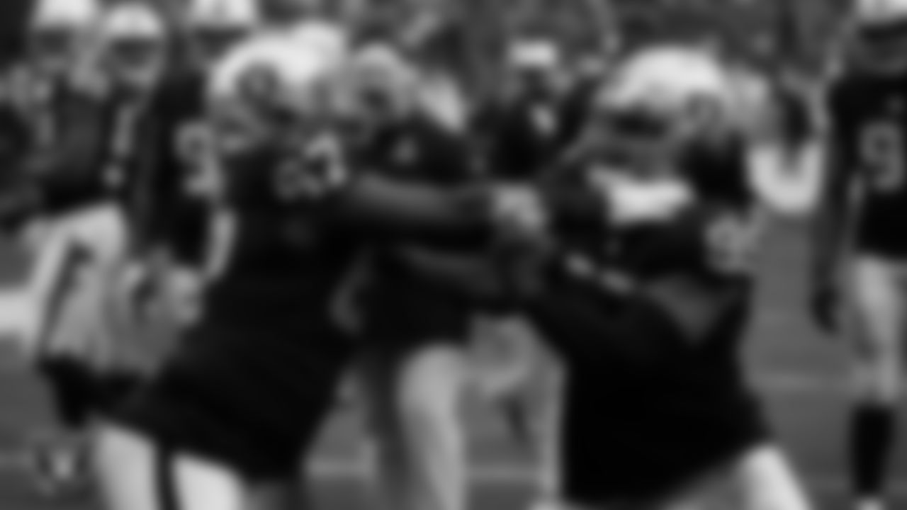 Las Vegas Raiders guard Lester Cotton Sr. (67) and defensive end Kendal Vickers (95) warming up before the regular season home game against the Houston Texans at Allegiant Stadium.