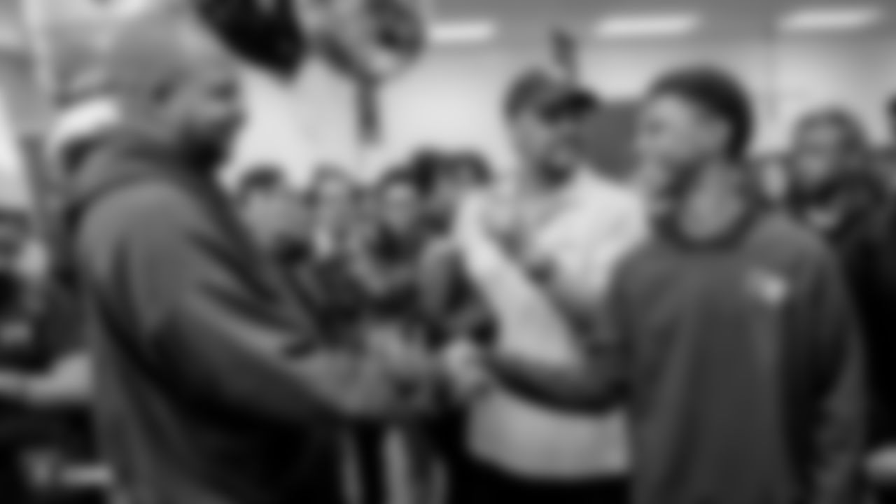 As part of American Education Week, a student shakes hands with Kenneth Boyd of Jerome Mack Middle School at a ceremony to recognize his hard work and dedication as a Clark County School District support staff.