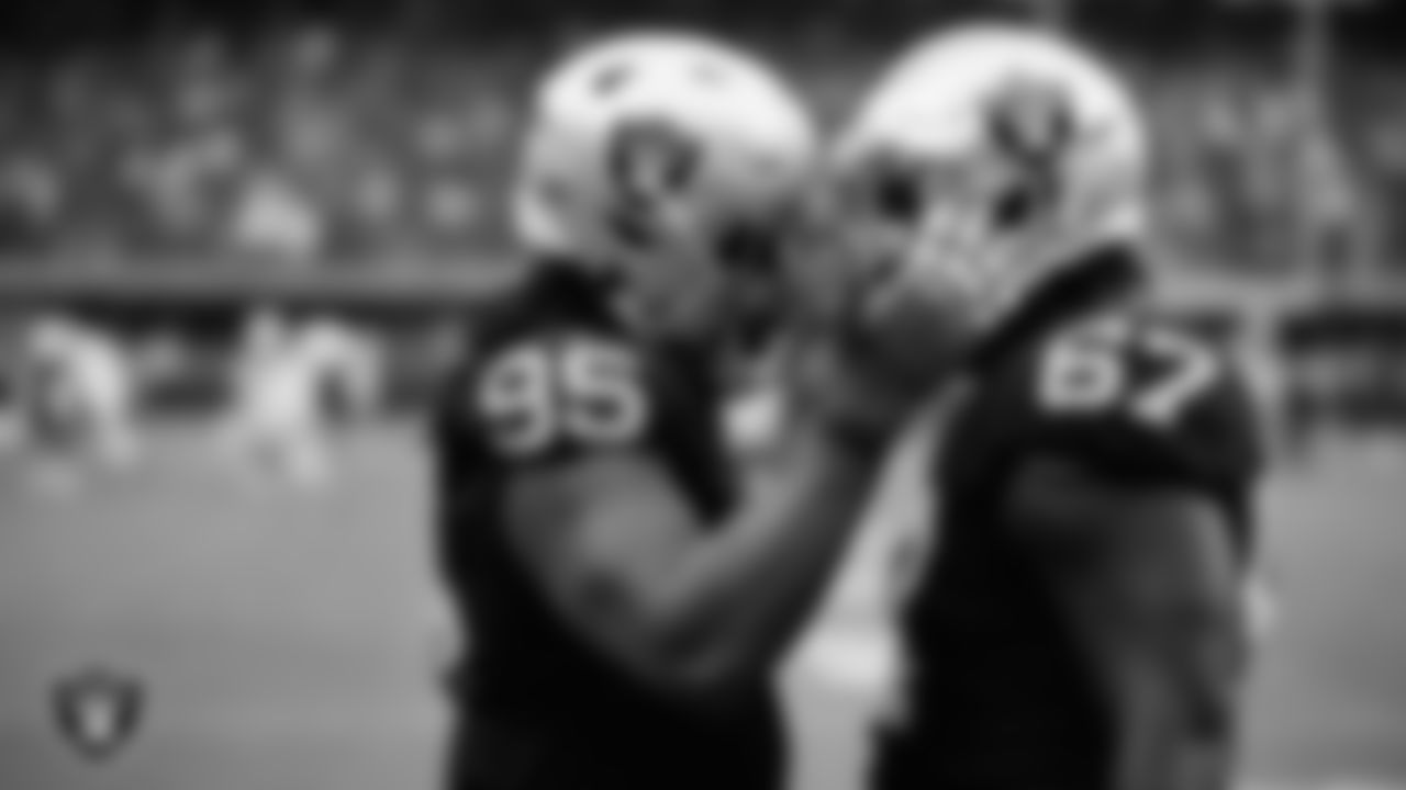 Las Vegas Raiders defensive end Kendal Vickers (95) and guard Lester Cotton Sr. (67) warming up before the regular season home game against the Arizona Cardinals at Allegiant Stadium.