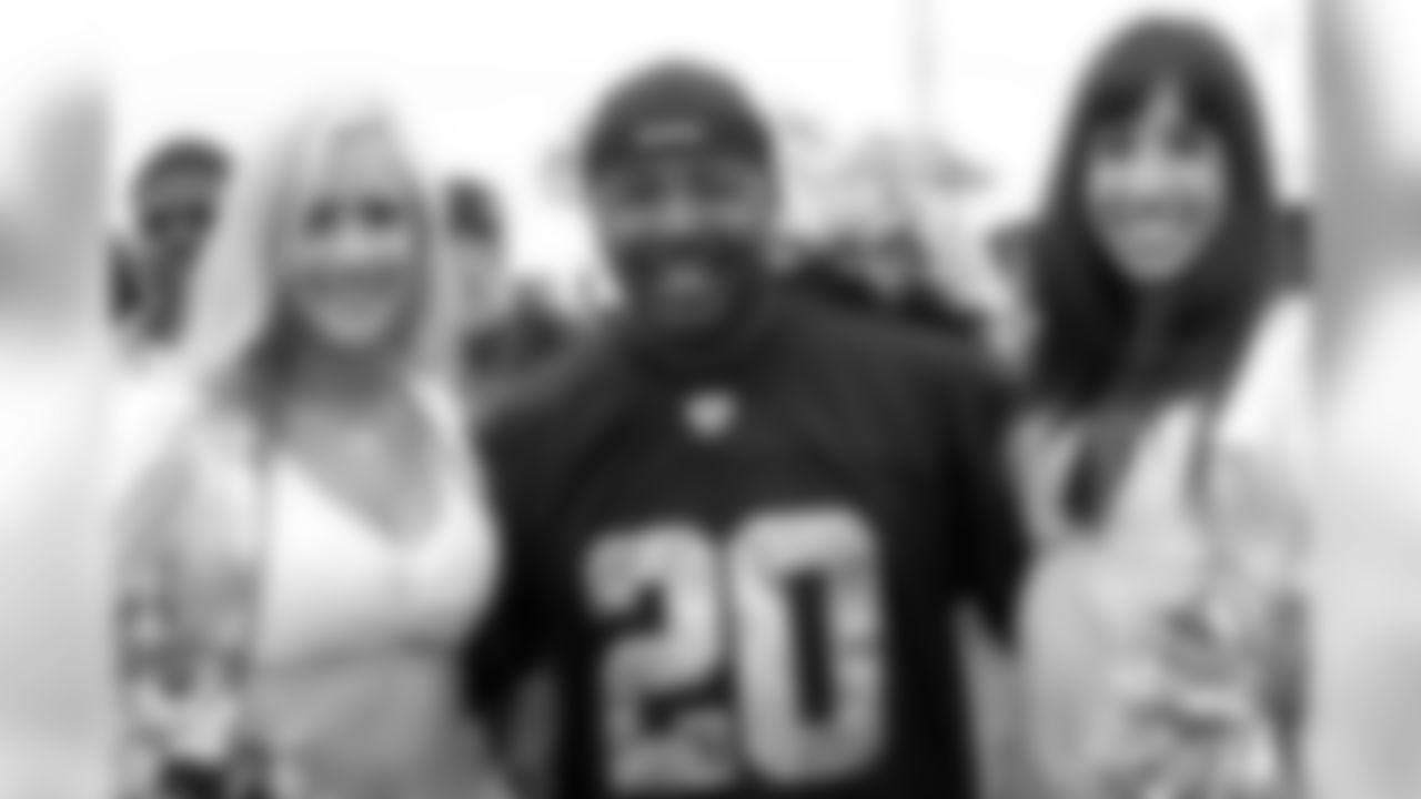 A Raider fan poses with Raiderettes Jonni and Ashley. Photo by Tony Gonzales.